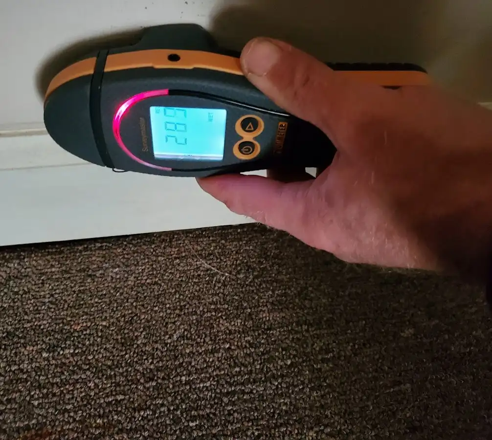 Moisture detection at baseboard during Storm Damage Restoration in Tulare